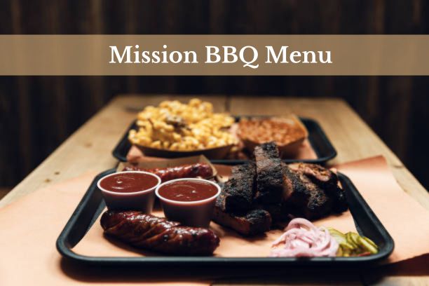 A plate of smoked brisket, pulled pork, and classic BBQ sides.